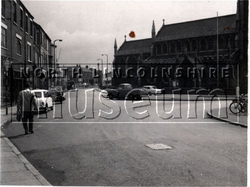 The lower end of Scunthorpe High Street showing St. John's Church in August 1966 	