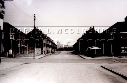 Lindsey Street, New Frodingham, Scunthorpe, taken from Cliff Street on 27 August 1962 with St. John's Church on the horizon 	