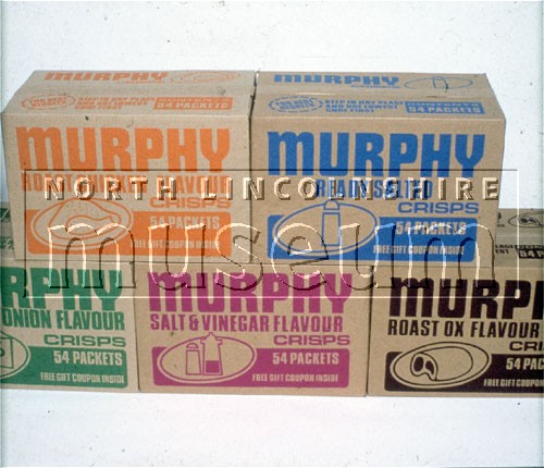 Boxes of different flavoured packets of Murphy's crisps made by Riley's Potato Crisps at their factory in Colin Road, Scunthorpe, c.late 1970's 	