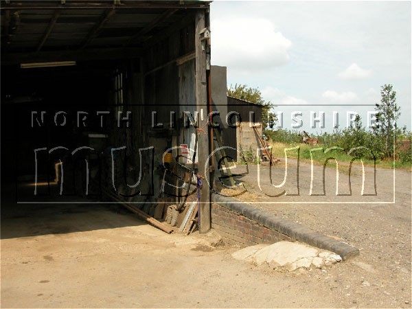 Ramp next to a barn at the eastern end of the platform of the former North Lindsey Light Railway station at Winteringham in July 2006 	