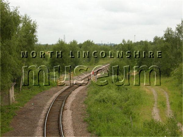 Record photograph looking north at a crossing over the remaining single track of the North Lindsey Light Railway north of Scunthorpe on the road to Winterton on 15 June 2006 	